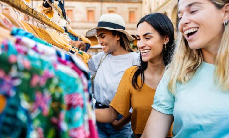 Happy,Women,Buying,Clothes,In,Second,Hand,Vintage,Market,In