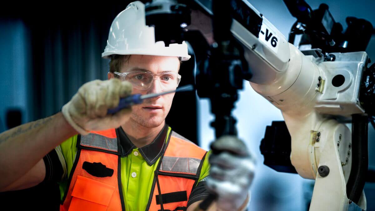 An,Engineer,Programs,Or,Repairs,A,High-tech,Industrial,Robot.,This