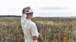 A,Person,Stands,In,A,Severely,Withered,Bean,Field,In