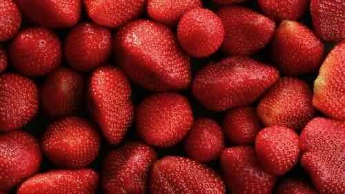 Fresh ripe strawberries as background, top view